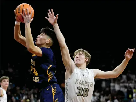  ?? MATTHEW JONAS — STAFF PHOTOGRAPH­ER ?? Frederick’s Matias Aldana, left, shoots past Air Academy’s Grant Feathersto­n during Friday’s Class 5A state semifinal game played at the Denver Coliseum.