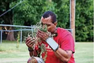  ?? [PHOTO BY ANYA MAGNUSON, THE OKLAHOMAN] ?? The Rev. Jamaal Jackson, associate pastor at Generation­s Church, smells fresh herbs he picked in the church’s community garden in Norman.