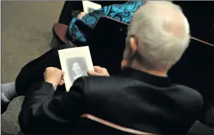  ?? Christian Monterrosa/The Signal ?? Former city councilman Carl Boyer looks at a photo of his friend, Jo Anne Darcy, who died last month. Boyer attended Darcy’s memorial service on Sunday in Newhall.