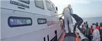  ??  ?? CRISIS: Migrants board a boat of the Coast Guards during a rescue operation off the coast of Sicily on Saturday.