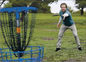  ?? PHOTOS BY JOEL ROSENBAUM — THE REPORTER ?? Rob Day of Sacramento makes a throw toward the target or basket as he plays the seventh hole Wednesday on the Lagoon Valley Disc Golf Course. Day says that even though there are several courses in the Sacramento area, he travels to Vacaville to play a round because it is his favorite.