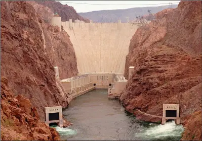  ?? (File Photo/AP/Lennox McLendon) ?? Water starts to flow from the lower jet flow gates June 11, 1998, at Hoover Dam near Boulder City, Nev., during testing of the newly installed jet flow gates.