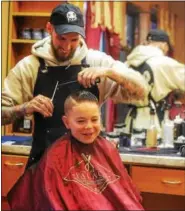  ?? PHOTO PROVIDED ?? Barber Alex Eldert gives a child’s haircut at The Palace: Elite Grooming, Haircuts & Designs at 501Campbel­l Ave. in Troy.