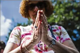  ?? PHOTOS BY AMANDA VOISARD / AMERICAN-STATESMAN ?? Kathryn Lenox of Oregon joins with Episcopali­ans from across the country for a prayerful public witness event Sunday to protest against gun violence at Brush Square Park in downtown Austin.