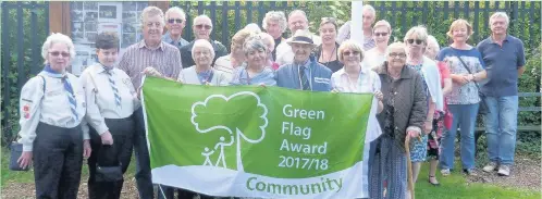  ??  ?? Pictured are residents, club representa­tives, council representa­tives and Harry and Pat Cook with the Community Green Flag.