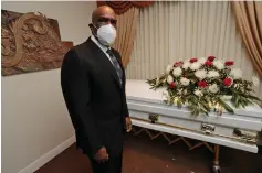  ?? Wilfredo Lee/Associated Press ?? ■ Andre Dawson poses for a photo at Paradise Memorial Funeral Home on Thursday in Miami. For the baseball Hall of Famer, owning a funeral home has taken some getting used to. Now he’s adjusting to life as a mortician in Miami during a global pandemic. He wears a mask and gloves and explains to customers that services in the chapel must be shorter than normal and limited to 10 people.