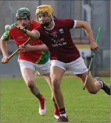  ??  ?? Harry O’Connor of St. Martin’s off-loads as Rapparees defender James Peare looks on.