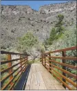  ??  ?? Left, from top: A helicopter brings in I-beams and deck for the new La Junta Bridge. The completed bridge connecting Cebolla Mesa Trail and Wild Rivers.