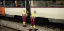  ?? ADRIAN QUIROGA - THE ASSOCIATED PRESS ?? Workers look at a damaged train on the platform of a train station in Barcelona, Spain, Friday. Catalan government officials say dozens of people were treated for injuries when a morning commuter train they were traveling on crashed into the buffers in...