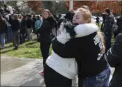  ?? CHRISTOPHE­R CHUNG — THE PRESS DEMOCRAT VIA AP ?? Misty Lenwell, mother of Jayden Pienta, receives a hug after speaking to students during a walkout at Montgomery High School in Santa Rosa on Monday. Pienta was fatally stabbed during a fight between students in a classroom at the school last week.