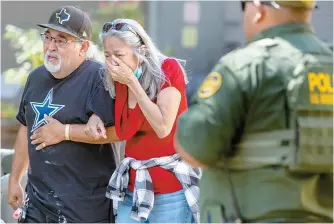  ?? AP-Yonhap ?? A woman cries as she leaves the Uvalde Civic Center in Uvalde, Texas, Tuesday. An 18-year-old gunman opened fire at a Texas elementary school, killing 19 children and two teachers and wounding others, and the gunman was dead.