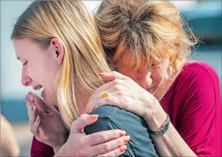  ?? STUART VILLANUEVA/THE GALVESTON COUNTY DAILY NEWS VIA AP ?? Santa Fe High School student Dakota Shrader is comforted by her mother, Susan Davidson, following a shooting at the school on Friday in Santa Fe, Texas. Shrader said her friend was shot in the incident. Visit www.theday.com for more photos.