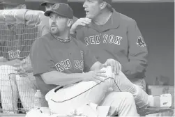  ?? KRUPA/AP ?? With his right foot in a cast, Red Sox catcher Jason Varitek watches the first inning against the Orioles during a July 2010 game at Fenway Park in Boston.CHARLES