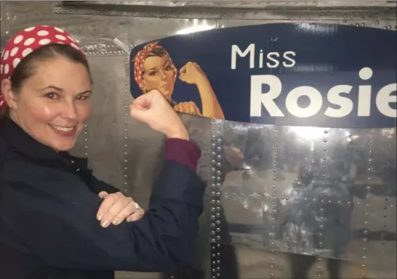  ?? JANET PODOLAK — FOR THE NEWS-HERALD ?? A Yankee Air Museum volunteer tells the story of Rosie the Riveter, the World War II icon who originated with the thousands of women building bombers at Willow Run in World War II.