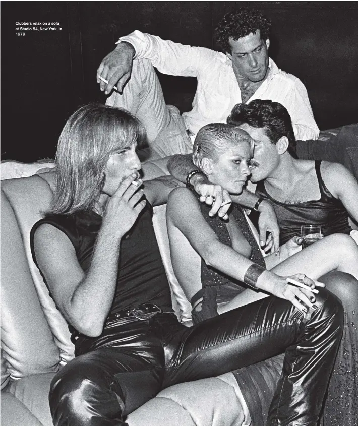  ??  ?? Clubbers relax on a sofa at Studio 54, New York, in 1979