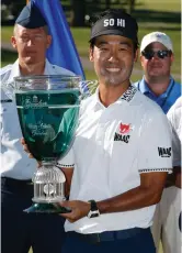  ?? Associated Press ?? ■ Kevin Na holds the trophy after winning the Military Tribute PGA Tour Golf Tournament on Sunday at the Greenbrier in White Sulphur Springs, W.Va.