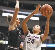  ?? Jessica Hill / Associated Press ?? UConn’s Napheesa Collier, right, shoots over South Carolina’s Mikiah Herbert Harrigan Monday night.