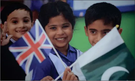 ??  ?? Smiling youngsters wave the flags of the UK and Pakistan, above and below, Lord Provost Eva Bolander was joined by the British Consul to Pakistan, Jon Ryan with Muhammad Akbar and Qureshi Daud Ahmad from the Ahmadiyya Muslim Associatio­n Pictures:...