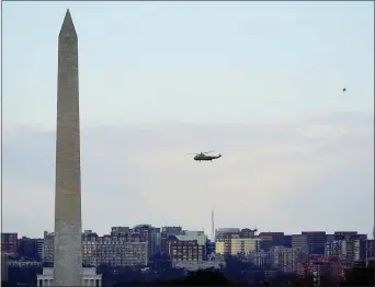  ?? PATRICK SEMANSKY — THE ASSOCIATED PRESS ?? Marine One helicopter, with President Donald Trump and first lady Melania Trump aboard, flies over the National Mall in Washington, Wednesday, Jan. 20, 2021.