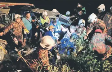  ??  ?? Rescuers helping out a survivor. — AFP photo