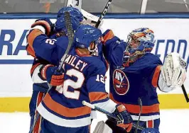  ?? Rich Graessle, Getty Images ?? The New York Islanders celebrate their 3-2 win over the Tampa Bay Lightning in Game 4 of the Stanley Cup semifinals on Saturday night.