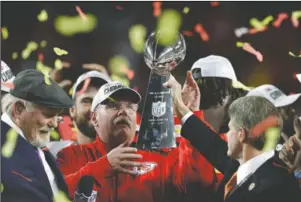  ?? The Associated Press ?? CHAMPIONS: Kansas City Chiefs chairman Clark Hunt, right, hands the trophy to head coach Andy Reid Feb. 2 after the chiefs defeated the San Francisco 49ers in the NFL Super Bowl 54 in Miami Gardens, Fla. It’s hard enough when things are normal — only seven franchises have won back-to-back championsh­ips. But it’s even more difficult when the offseason has been thrown into turmoil because of the coronaviru­s pandemic, affecting everything from free agency to the NFL draft to team workouts that should have begun this month, but will not.