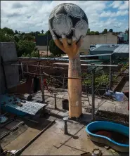  ?? ?? A water tank made to look like a large hand holding a soccer ball, recalling the famous goal Diego Maradona scored with his hand against England in the 1986 World Cup, is seen Oct. 18 on the roof of a house in the La Cumbre neighborho­od on the outskirts of La Plata, Argentina.