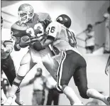  ?? [DOUG HOKE/THE OKLAHOMAN] ?? Once a regular rivalry, Oklahoma State and Arkansas played football each year between 19621980, as they did in this 1978 photo showing OSU's Worley Taylor trying to get away from Arkansas' Dan Hampton.