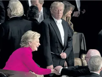  ?? ANDREW HARNIK/AP PHOTO ?? Republican presidenti­al candidate Donald Trump, center, watches as Democratic presidenti­al candidate Hillary Clinton greets guests at the conclusion of the 71st annual Alfred E. Smith Memorial Foundation Dinner, a charity gala organized by the...