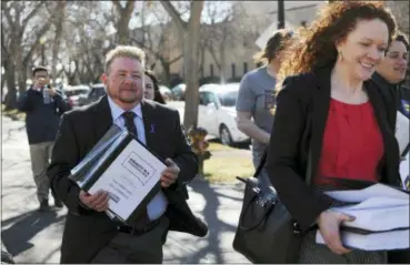  ?? JAMES NORD — THE ASSOCIATED PRESS FILE ?? In this file photo, Terri Bruce, left, walks toward the state Capitol in Pierre, S.D. Bruce said a new South Dakota bill to ban public school teaching on gender identity in elementary and middle schools would have unintended consequenc­es and send a...