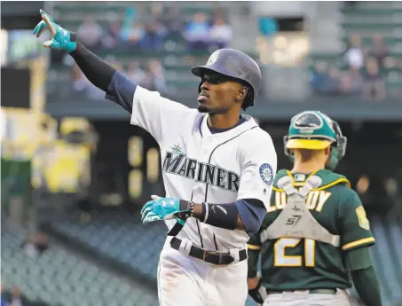  ?? Ted S. Warren / Associated Press ?? Seattle’s Dee Gordon scores on a Robinson Cano single in the first. He scored again in the third as the Mariners jumped in front.