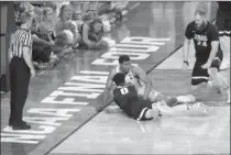  ?? MATT YORK, THE ASSOCIATED PRESS ?? North Carolina’s Kennedy Meeks places his right hand outside of the line as Meeks and Gonzaga’s Silas Melson (0) battle for a loose ball in the final minute of Monday night’s championsh­ip game.