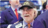  ?? RICHARD DREW/ ASSOCIATED PRESS ?? Trader Peter Tuchman wears a “Dow 23,000” hat as he works on the floor of the New York Stock Exchange on Wednesday.