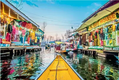  ??  ?? The Dal Lake’s picturesqu­e market, houseboats and the floating vegetable gardens together provide a means of livelihood to a large number of people