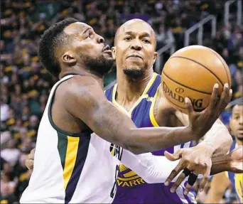  ?? Gene Sweeney Jr./Getty Images ?? Utah’s Shelvin Mack, left, attempts to drive around Golden State’s David West in Game 3 of their second-round series Saturday night in Salt Lake City.