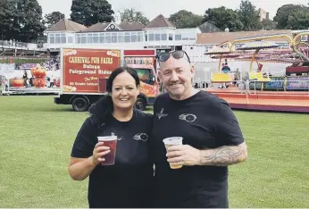  ??  ?? Carla and Tom Cuthbertso­n raise a toast at the end of this year’s bike ride in memory of their son.