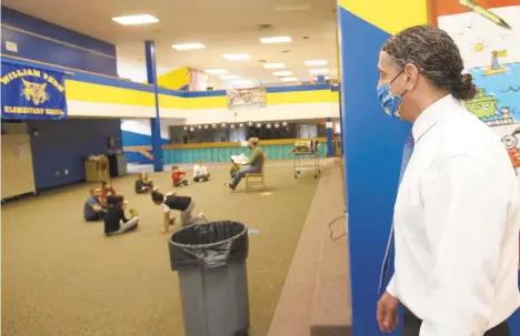  ?? RICKKINTZE­L/THE MORNING CALL ?? Jonathan DeRaymond, a guidance counselor at William Penn Elementary School, walks through the Bethlehem school. He is tasked with checking on the well-being of the 230 students at William Penn during this unusual school year.