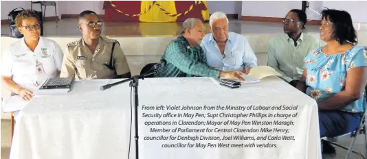  ??  ?? From left: Violet Johnson from the Ministry of Labour and Social Security office in May Pen; Supt Christophe­r Phillips in charge of operations in Clarendon; Mayor of May Pen Winston Maragh; Member of Parliament for Central Clarendon Mike Henry; councillor for Denbigh Division, Joel Williams, and Carla Watt, councillor for May Pen West meet with vendors.