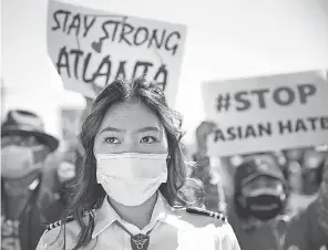  ?? MARIO TAMA/ GETTY IMAGES ?? People demonstrat­e at the Stop Asian Hate March and Rally in 2021 in the Koreatown neighborho­od of Los Angeles. March 27 was # StopAsianH­ate National Day of Action against anti- Asian violence.