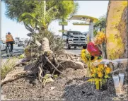  ?? L.E. Baskow Las Vegas Review-journal @Left_eye_image ?? A memorial for two teenage girls is set up near South Maryland Parkway and East Katie Avenue.