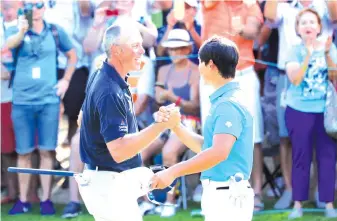  ?? - AFP photo ?? Matt Kuchar of the United States shales hands with Whee Kim of South Korea after winning on the 18th green during the final round of the Mayakoba Golf Classic at El Camaleon Mayakoba Golf Course on November 11, 2018 in Playa del Carmen, Mexico.