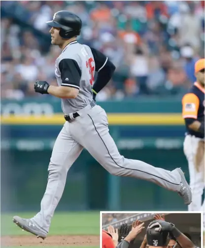  ?? GETTY IMAGES (ABOVE), AP ?? Sox catcher Kevan Smith, wearing a jersey honoring late friend and teammate Daniel Webb, rounds the bases after his home run Saturday against the Tigers.