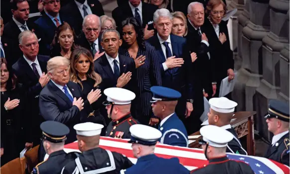 ?? JACK GRUBER/USA TODAY ?? President Trump and Melania Trump pay their respects with Barack and Michelle Obama, Bill and Hillary Clinton and Jimmy and Rosalynn Carter.