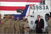  ?? AP PHOTO/ALEX BRANDON ?? President Donald Trump speaks aside to members of the Office of Air and Marine of the U.S. Customs and Border Protection during a tour of U.S. Customs and Border Protection Border equipment at their airport hanger at Marine Corps Air Station Yuma on...