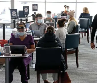  ?? MAtt stoNE / hERAlD stAFF FilE ?? PRICEY PLACE: Patients are screened before getting their COVID-19 vaccine at the CIC Health vaccinatio­n site at Gillette Stadium in Foxboro on Jan. 18. The $625,440 weekly price tag for Gillette includes $280,865 in expenses and a minimum weekly payment of $344,575.