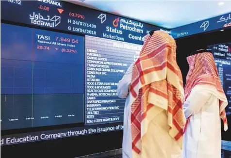  ?? Bloomberg ?? ■ Stock price informatio­n displayed in the Saudi Stock Exchange, also known as the Tadawul, in Riyadh. Foreign investors bought more Saudi stocks in March than ever before.