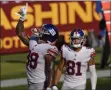  ?? SUSANWALSH - THE ASSOCIATED PRESS ?? New York Giants tight end Evan Engram (88) pointing upwards after scoring a touchdown against the Washington Football Team, Sunday, Nov. 8, 2020, in Landover, Md. Also on the field is teammate wide receiver Austin Mack (81).