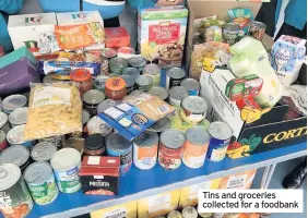  ??  ?? Tins and groceries collected for a foodbank