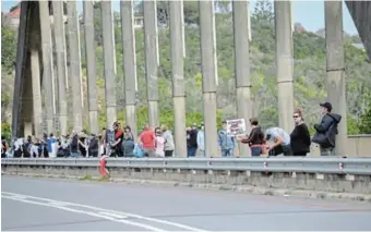  ?? Picture: JON HOUZET ?? LOCAL SUPPORT: Some of the throngs which lined the Nico Malan Bridge for the Move One Million protest last Saturday, with placards denouncing farmer murders, gender-based violence and government corruption