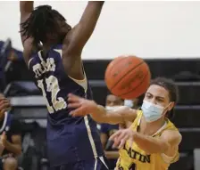  ?? PAUL CONNORS / BOSTON HERALD ?? NICE DISH: Latin Academy’s Benny Martinez passes around New Mission’s Kemar Morgan during the Boston City League championsh­ip on Saturday.